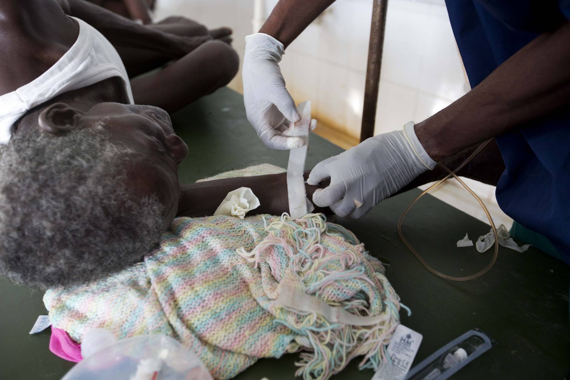 A doctor treats a cholera patient at a cholera center in Anse D'Hainault, Haiti, Tuesday, Oct. 11, 2016. The U.N. said Hurricane Matthew has increased the risk of a "renewed spike" in the number of cholera cases. (AP Photo/Dieu Nalio Chery)