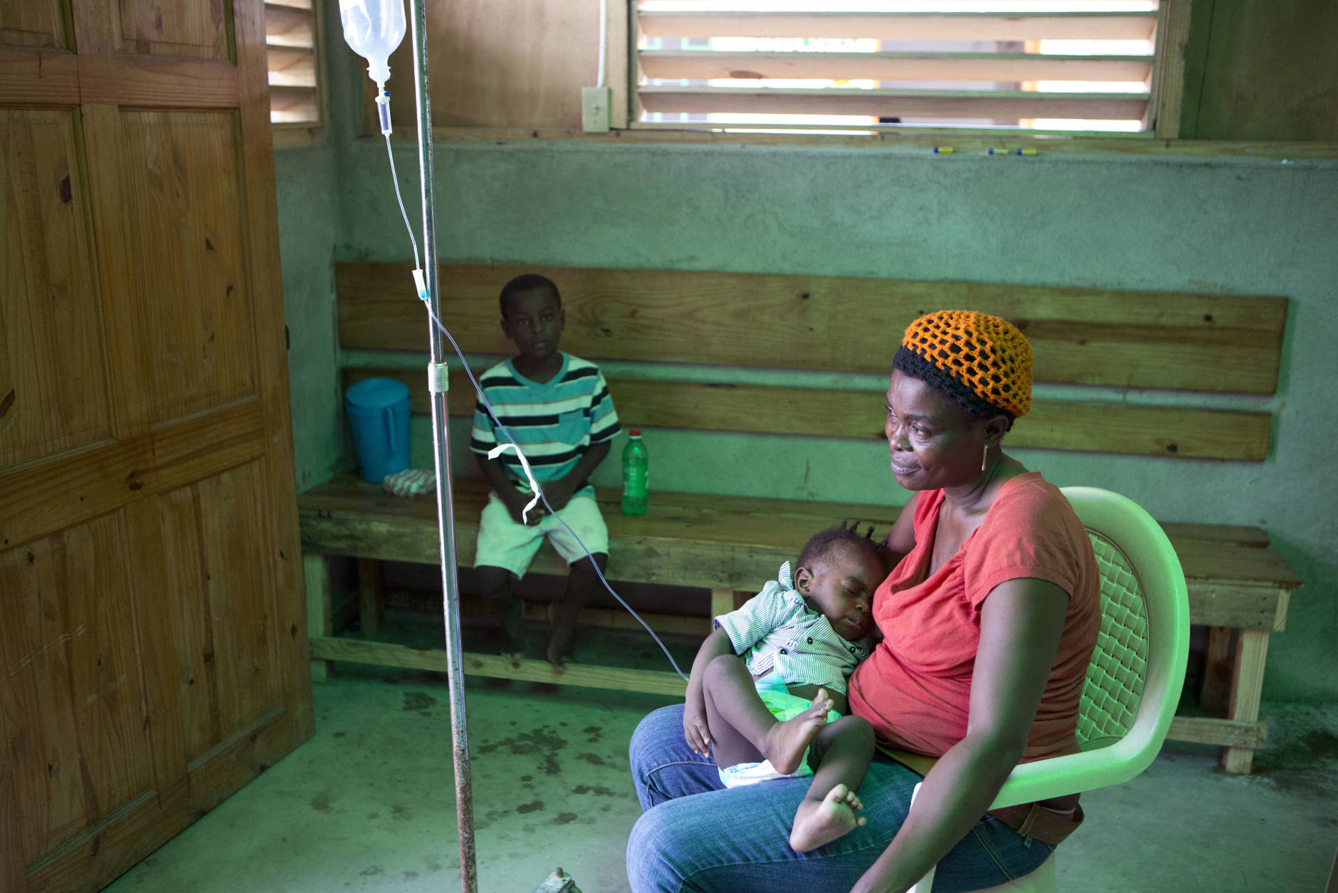 Denise Jabon holds her 7-month-old son Yamson Casi, as he rests hooked up to an IV in a cholera ward in Les Cayes Haiti, Tuesday, Oct. 11, 2016. Health authorities have warned that Hurricane Matthew has created conditions that are likely to cause an increase in the deadly waterborne cholera virus.(AP Photo/Rebecca Blackwell)