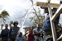 United Nations police from Bangladesh deliver drinking water to residents of Sous-Roche village, outside Les Cayes, Haiti, Tuesday, Oct. 11, 2016. Health authorities have warned that Hurricane Matthew has created conditions that are likely to cause an increase in the deadly waterborne cholera virus.(AP Photo/Rebecca Blackwell)