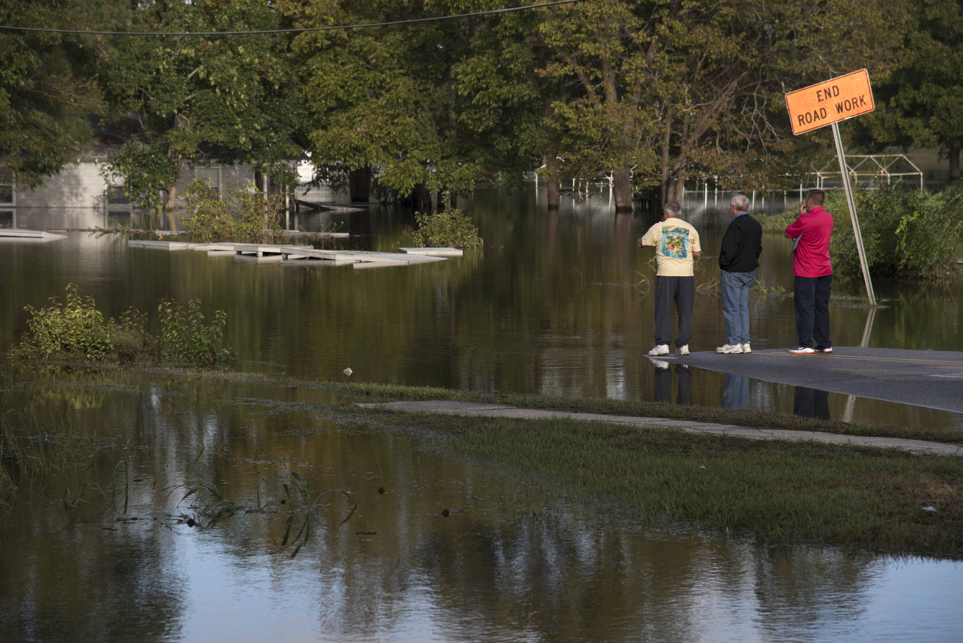 People look out towards West 5th Street that is covered by floodwaters caused by rain from Hurricane in Lumberton, N.C., Wednesday, Oct. 12, 2016. Gov. Pat McCrory says more damage is still to come for many people in the eastern part of North Carolina as the state faces its ninth day of Hurricane Matthew's aftermath.
(AP Photo/Mike Spencer)