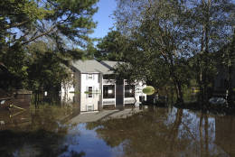 An apartment complex near the Tar River in Greenville, N.C., is seen surrounded by floodwaters on Wednesday, Oct. 12, 2016. Many houses and apartments near the river were already taking on water a day before the river swollen by Hurricane Matthew was forecast to crest on Thursday. (AP Photo/Jonathan Drew)