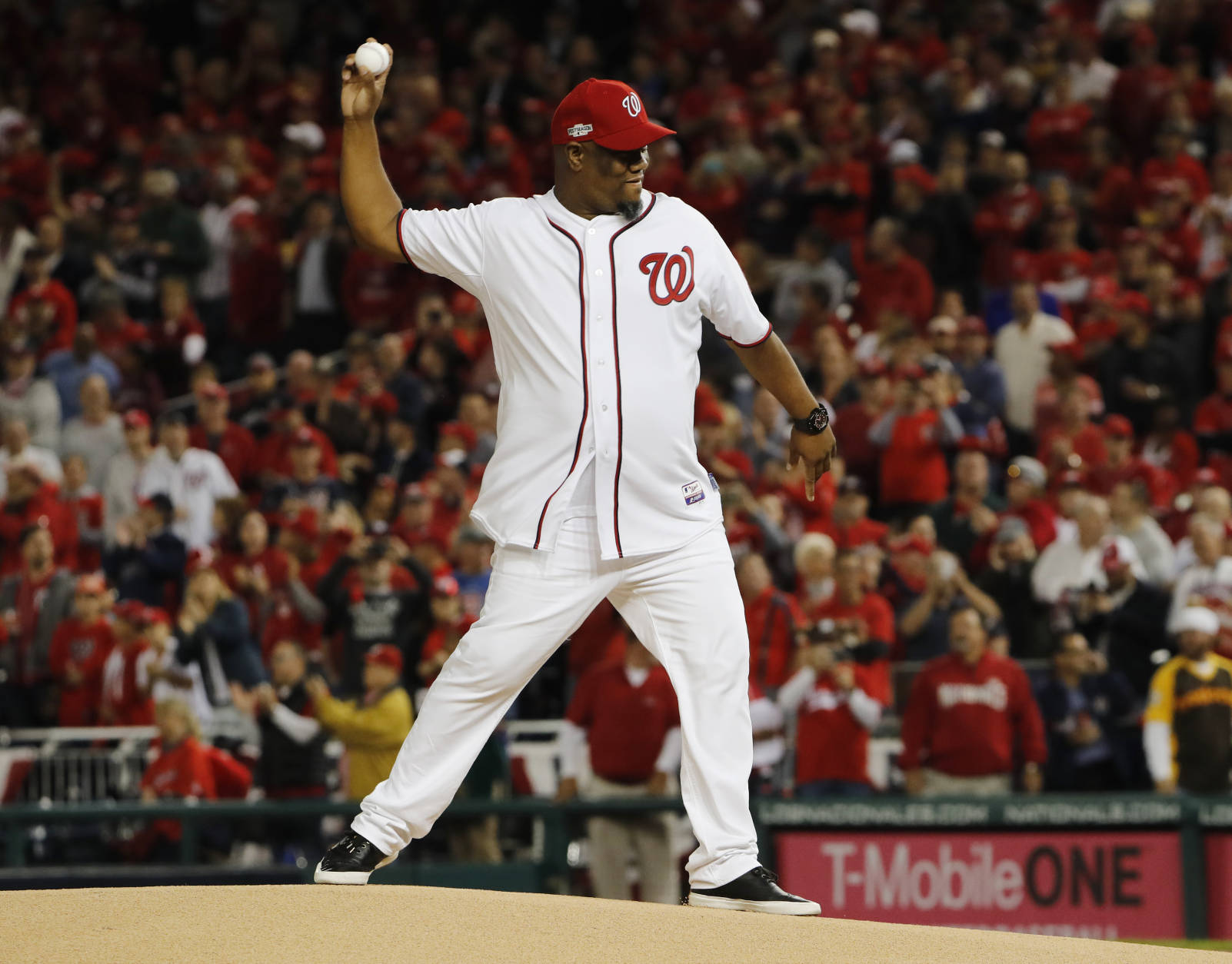 Former Washington Nationals pitcher Livan Hernandez throws out a ceremonial first pitch at Game 5 of baseball's National League Division Series between the Nationals and the Los Angeles Dodgers at Nationals Park, Thursday, Oct. 13, 2016, in Washington. (AP Photo/Pablo Martinez Monsivais)