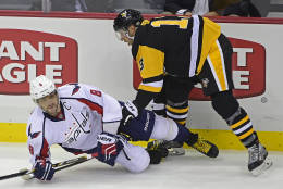 Washington Capitals left wing Alex Ovechkin (8) is knocked over by a Pittsburgh Penguins center Nick Bonino (13) check during the first period of an NHL hockey game Thursday, Oct. 13, 2016, in Pittsburgh, Pa. (AP Photo/Fred Vuich)