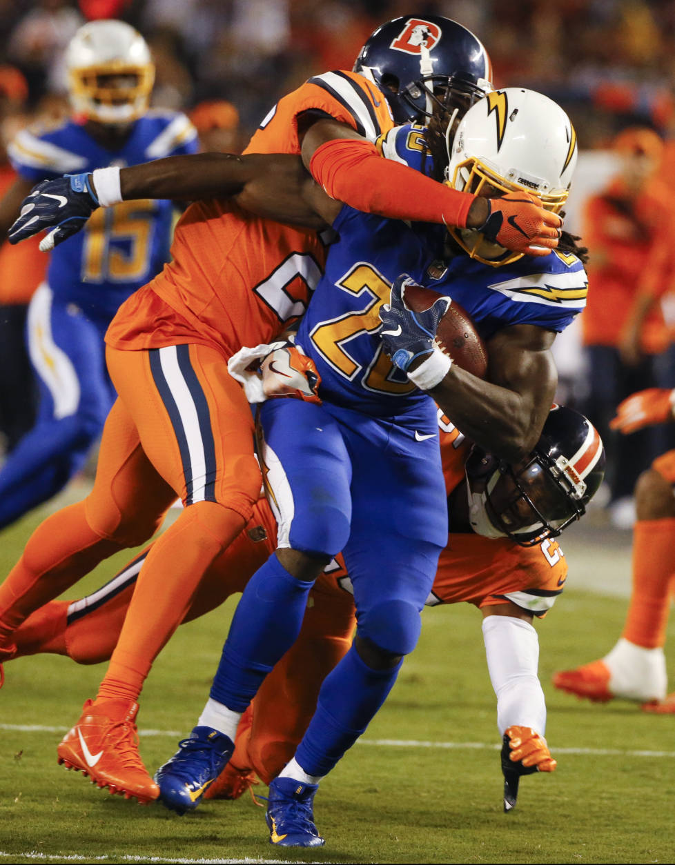 San Diego Chargers running back Melvin Gordon is brought down by Denver Broncos free safety Darian Stewart, above, and cornerback Chris Harris, below, during the second half of an NFL football game Thursday, Oct. 13, 2016, in San Diego. (AP Photo/Lenny Ignelzi)
