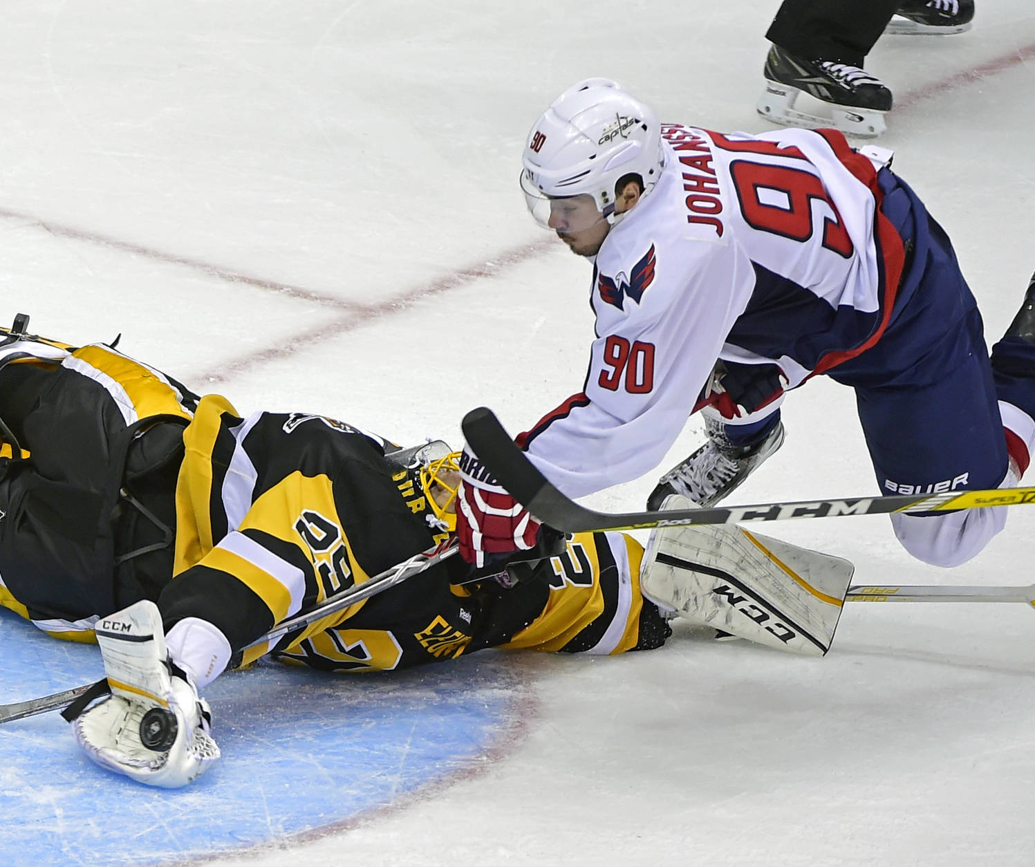 Pittsburgh Penguins goalie Marc-Andre Fleury (29) makes a save against Washington Capitals left wing Marcus Johansson (90), of Sweden,  during the third period of an NHL hockey game Thursday, Oct. 13, 2016, in Pittsburgh, Pa. (AP Photo/Fred Vuich)