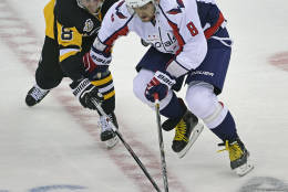 Pittsburgh Penguins defenseman Brian Dumoulin, left, and Washington Capitals left wing Alex Ovechkin (8) reach for the puck during the third period of an NHL hockey game Thursday, Oct. 13, 2016, in Pittsburgh. (AP Photo/Fred Vuich)