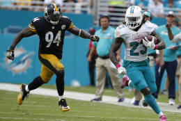 Miami Dolphins running back Jay Ajayi (23) runs ahead of Pittsburgh Steelers inside linebacker Lawrence Timmons (94), during the second half of an NFL football game, Sunday, Oct. 16, 2016, in Miami Gardens, Fla. (AP Photo/Wilfredo Lee)