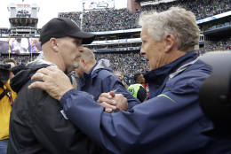 Seattle Seahawks head coach Pete Carroll, right, greets Atlanta Falcons head coach Dan Quinn after an NFL football game, Sunday, Oct. 16, 2016, in Seattle. (AP Photo/Elaine Thompson)