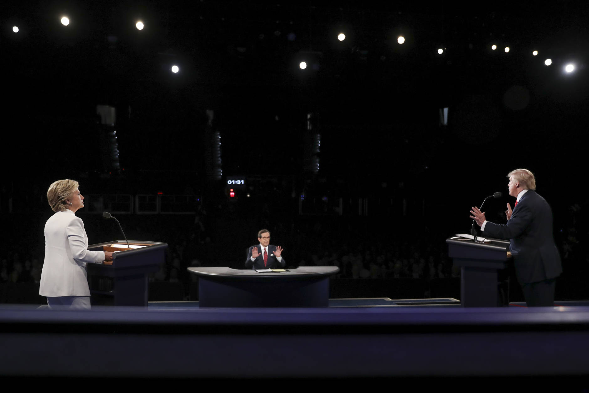 Democratic presidential nominee Hillary Clinton listen as Republican presidential nominee Donald Trump answers Moderator Chris Wallace's question during the third presidential debate at UNLV in Las Vegas, Wednesday, Oct. 19, 2016. (Joe Raedle/Pool via AP)