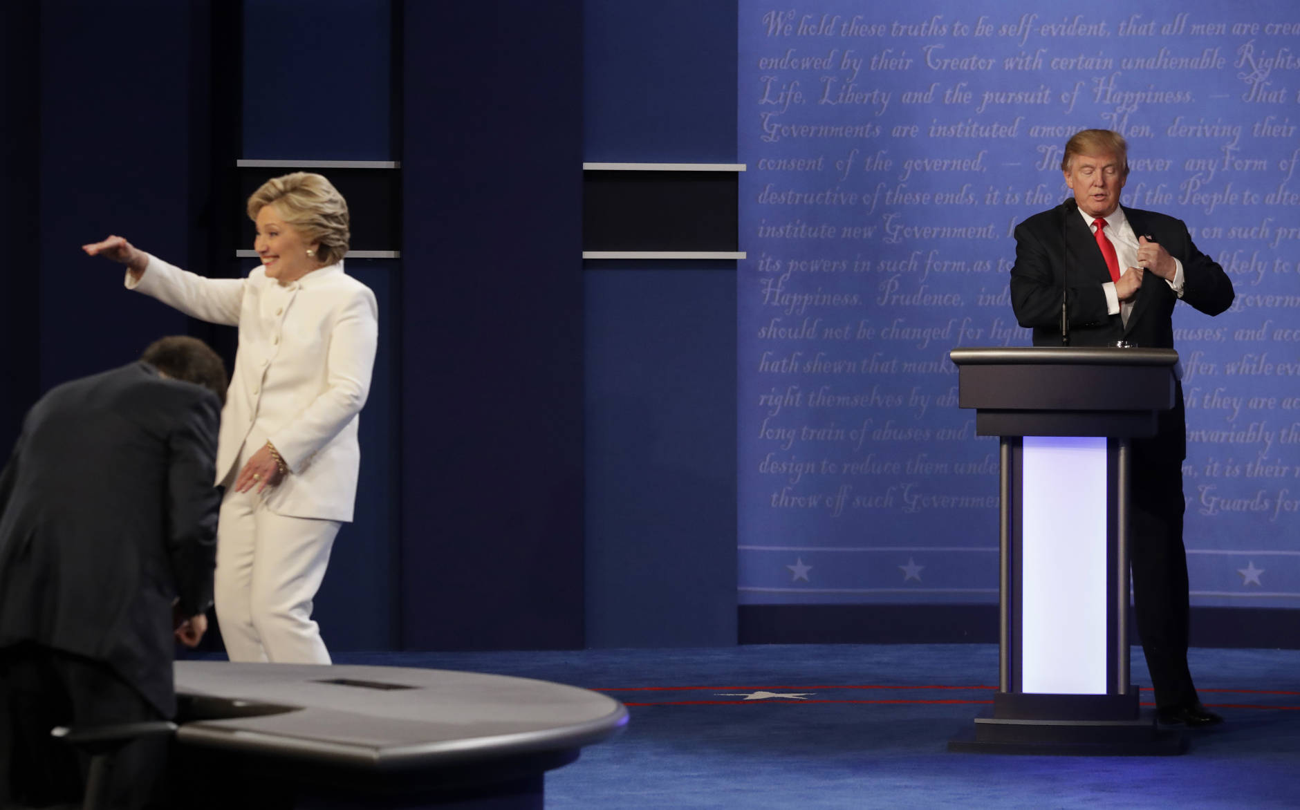 Republican presidential nominee Donald Trump waits behind his podium as Democratic presidential nominee Hillary Clinton makes her way off the stage following the third presidential debate at UNLV in Las Vegas, Wednesday, Oct. 19, 2016. (AP Photo/David Goldman)