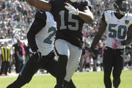 Raiders wide receiver Michael Crabtree (15) celebrates his two-yard touchdown reception in front of Jacksonville Jaguars cornerback Prince Amukamara (21) and outside linebacker Telvin Smith (50) during the second quarter of an NFL football game Sunday, Oct. 23, 2016, in Jacksonville, Fla. (AP Photo/Phelan Ebenhack)