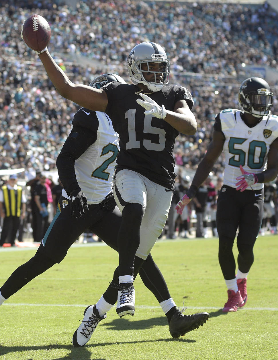 Raiders wide receiver Michael Crabtree (15) celebrates his two-yard touchdown reception in front of Jacksonville Jaguars cornerback Prince Amukamara (21) and outside linebacker Telvin Smith (50) during the second quarter of an NFL football game Sunday, Oct. 23, 2016, in Jacksonville, Fla. (AP Photo/Phelan Ebenhack)