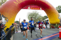 FILE -- Runners cross the finish line of the 41st Marine Corps Marathon, Sunday, Oct. 30, 2016 in Arlington, Va. The race includes runners from 55 nations and each branch of the U.S. armed forces. ( AP Photo/Jose Luis Magana)
