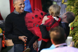 President Barack Obama laughs as he hands treats to children from Washington area and children of military families during a trick-or-treat celebrating Halloween at the South Portico of the White House in Washington, Monday, Oct. 31, 2016. (AP Photo/Manuel Balce Ceneta)