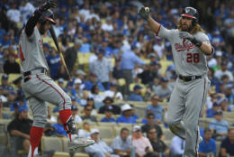Washington Nationals' Jayson Werth, left, celebrates after his home run with Bryce Harper during the ninth inning in Game 3 of baseball's National League Division Series in Los Angeles, Monday, Oct. 10, 2016. (AP Photo/Mark J. Terrill)