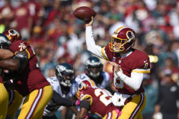 Washington Redskins quarterback Kirk Cousins throws to a receiver in the first half of an NFL football game against the Philadelphia Eagles, Sunday, Oct. 16, 2016, in Landover, Md. (AP Photo/Nick Wass)