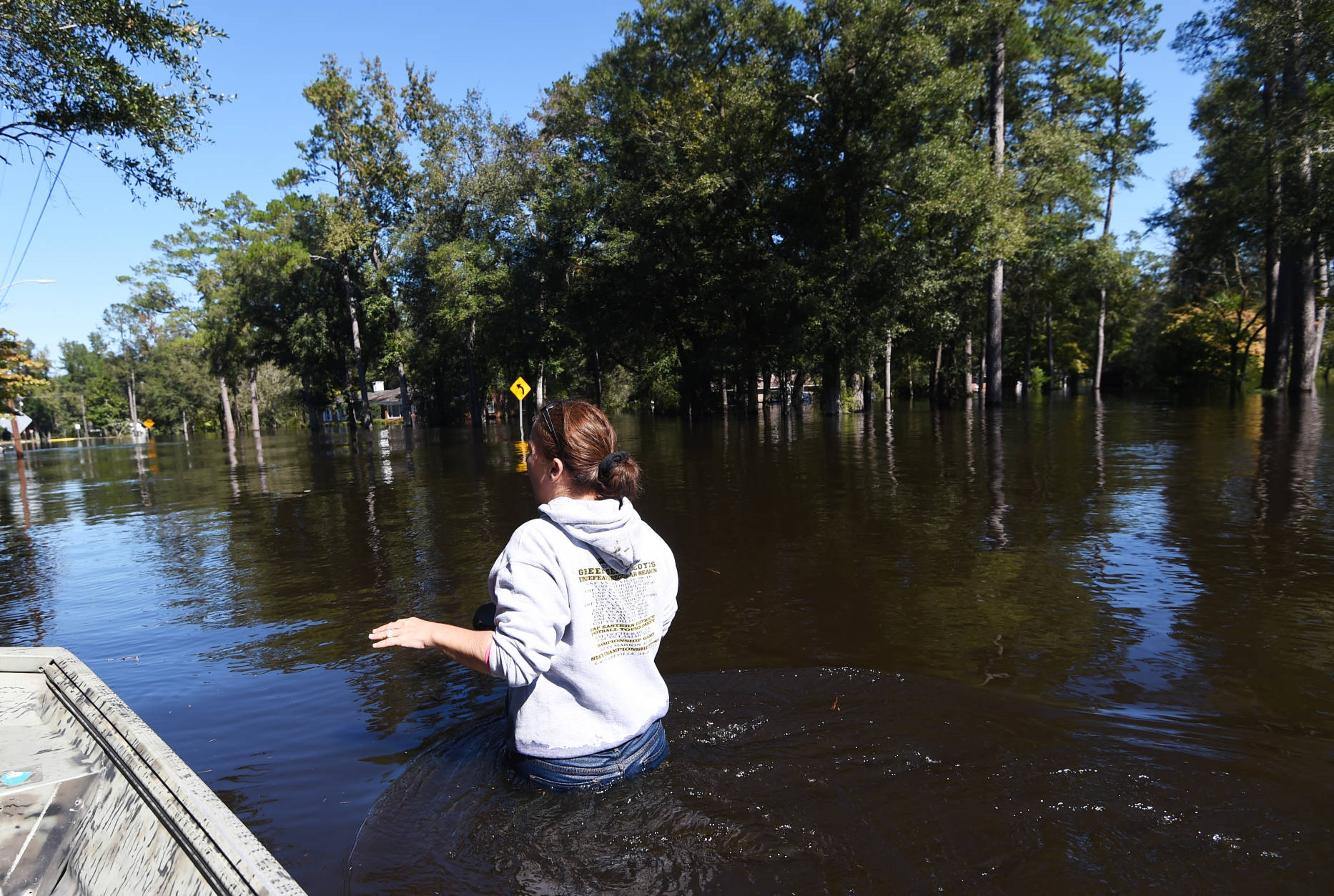 Natalie McDowell, left, walks to her flooded home on Tuesday, Oct. 11, 2016, in Nichols, S.C. About 150 people were rescued by boats from flooding in the riverside village of Nichols on Monday. (AP Photo/Rainier Ehrhardt)