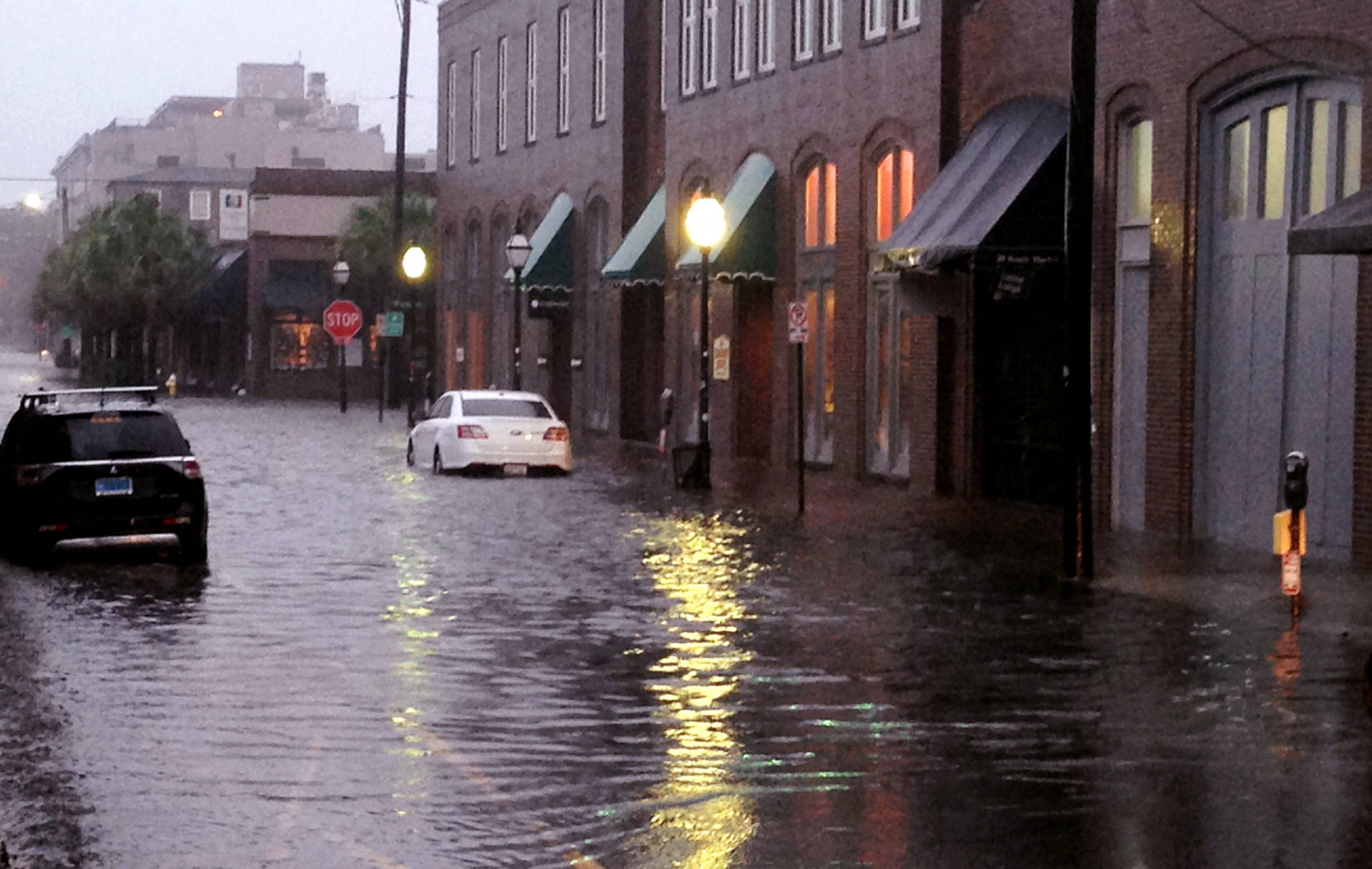 Flood waters rise around cars parked on a street near the popular City Market in Charleston, S.C., during Hurricane Matthew on Saturday, Oct. 8, 2016. The storm moved along the South Carolina coast with the worst winds hitting Charleston on Saturday morning.  (AP Photo/Bruce Smith)