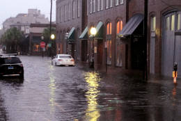 Flood waters rise around cars parked on a street near the popular City Market in Charleston, S.C., during Hurricane Matthew on Saturday, Oct. 8, 2016. The storm moved along the South Carolina coast with the worst winds hitting Charleston on Saturday morning.  (AP Photo/Bruce Smith)