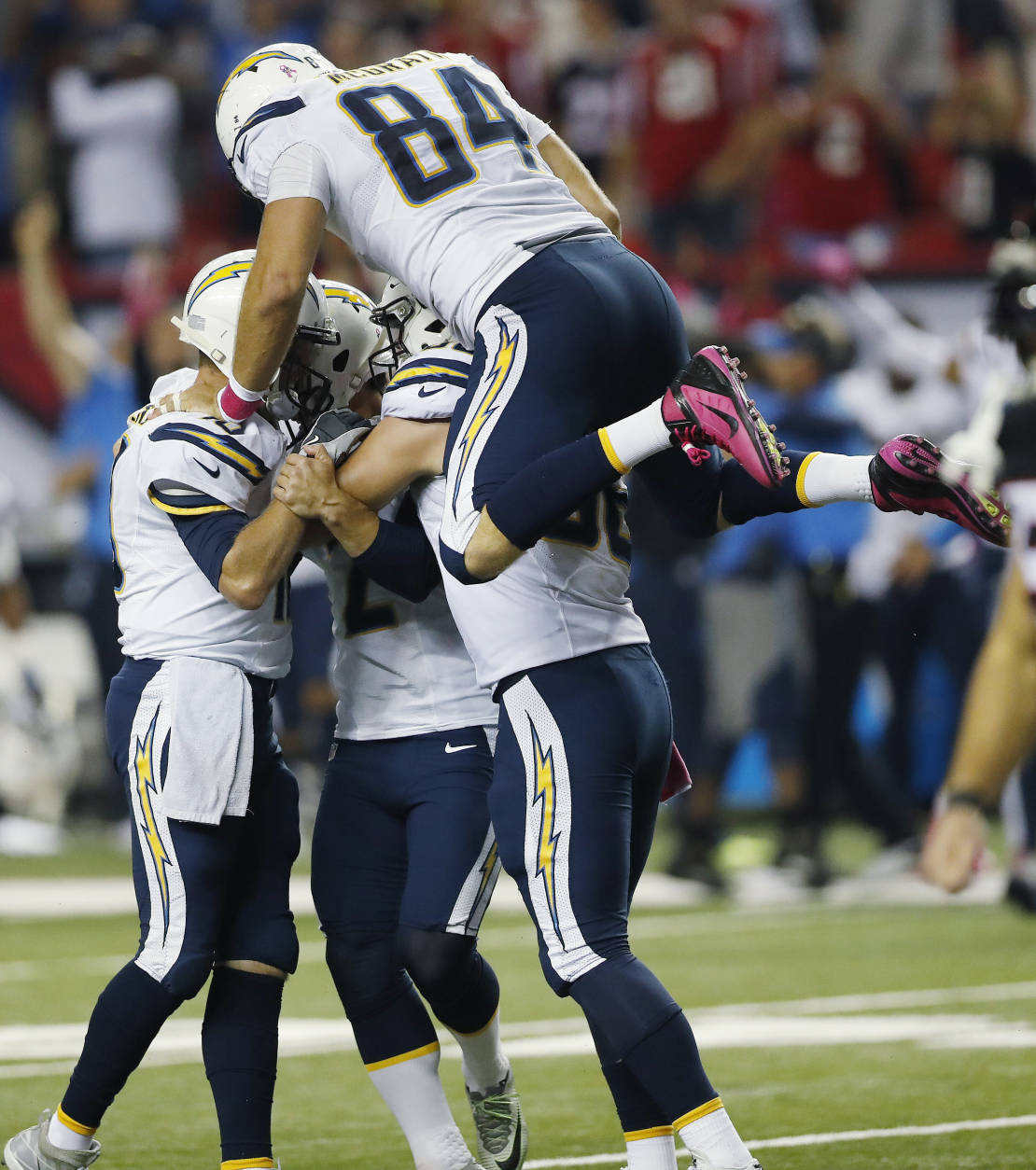 San Diego Chargers tight end Sean McGrath (84) jumps on San Diego Chargers kicker Josh Lambo (2) after Lambo kicked the game winning field goal in overtime of an NFL football game against the Atlanta Falcons, Sunday, Oct. 23, 2016, in Atlanta. The Chargers won 33-30. (AP Photo/John Bazemore)
