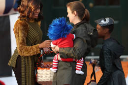 First lady Michelle Obama hands treats as she and President Barack Obama welcome children from Washington area and children of military families to trick-or-treat celebrating Halloween at the South Portico of the White House in Washington, Monday, Oct. 31, 2016. (AP Photo/Manuel Balce Ceneta)