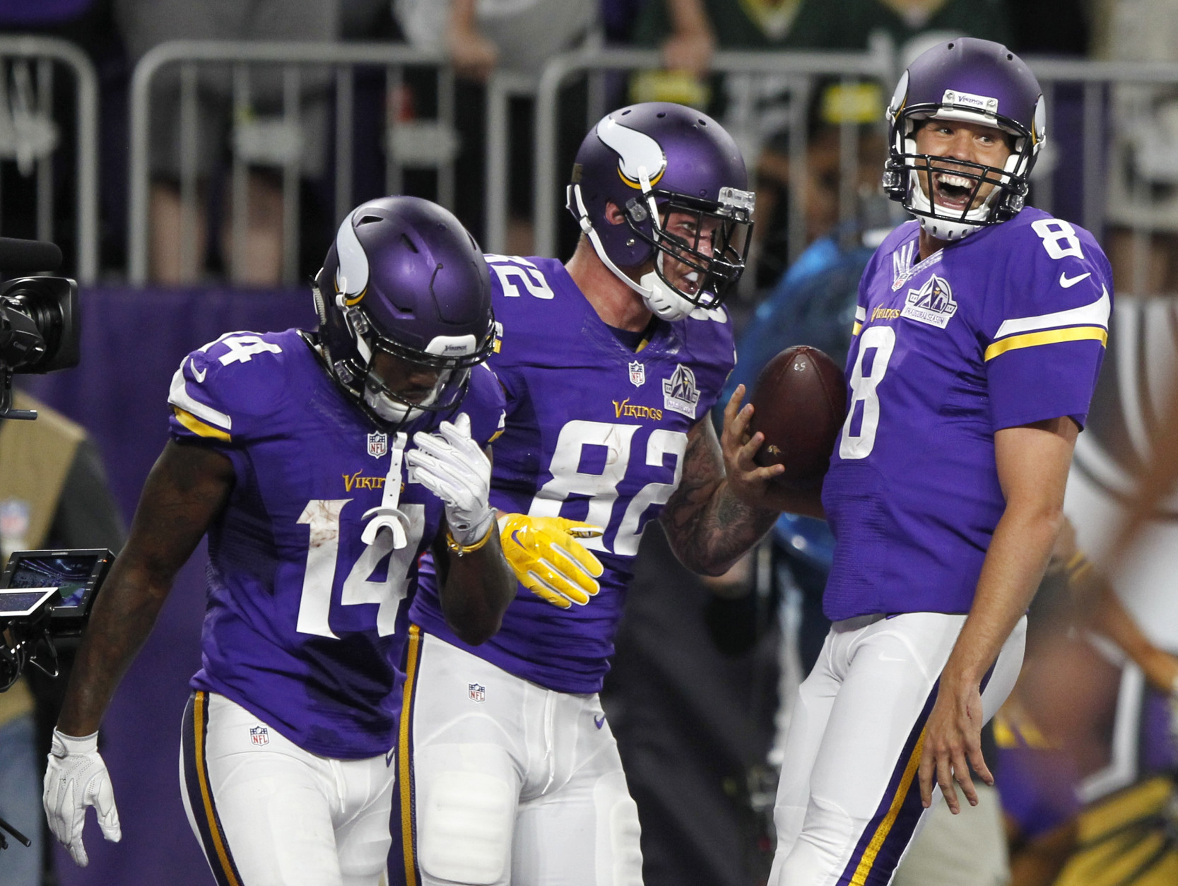 Minnesota Vikings tight end Kyle Rudolph, center, celebrates with teammates Stefon Diggs, left, and quarterback Sam Bradford, right, after catching an 8-yard touchdown pass during the first half of an NFL football game against the Green Bay Packers Sunday, Sept. 18, 2016, in Minneapolis. (AP Photo/Andy Clayton-King)