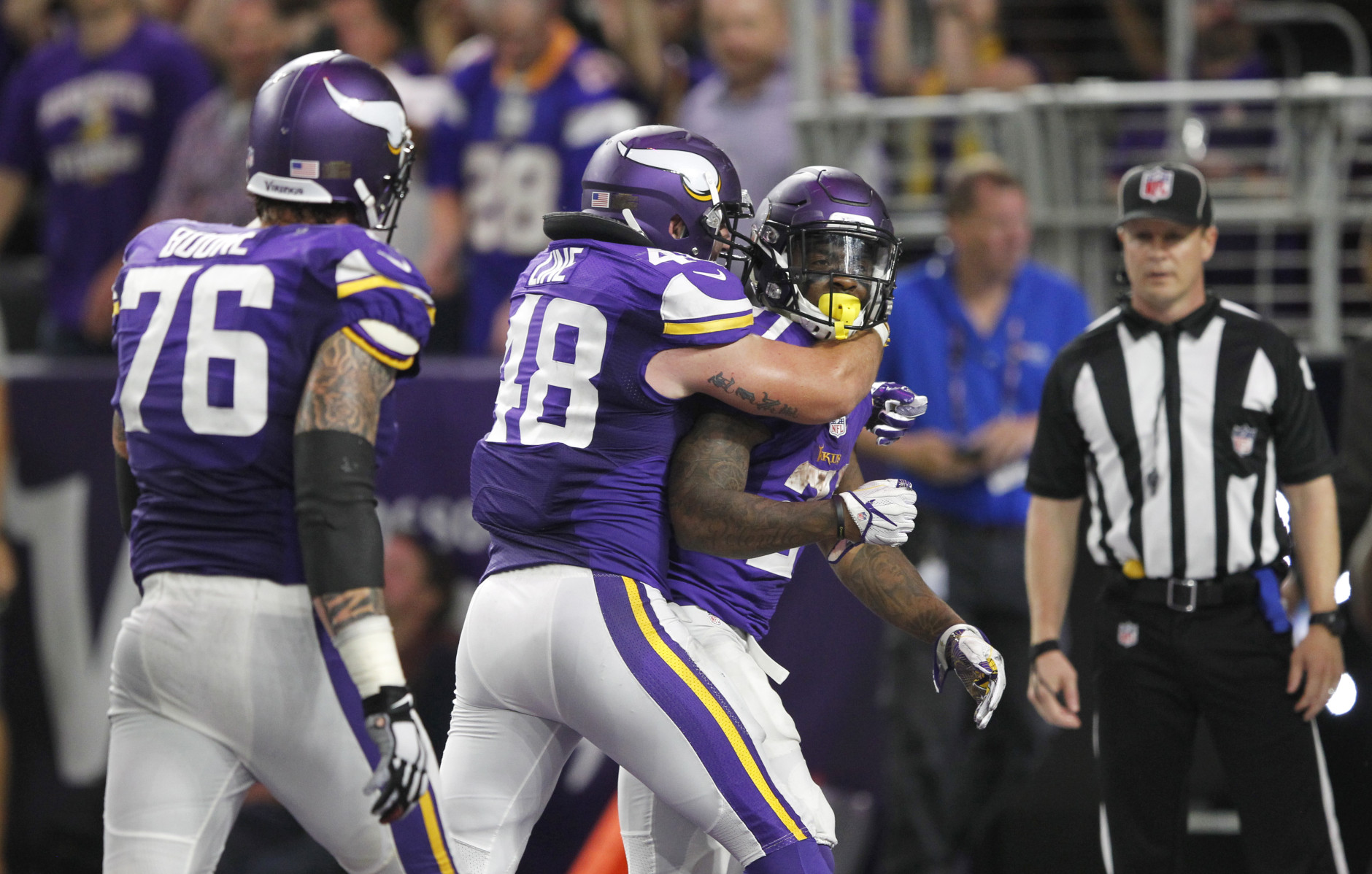 Minnesota Vikings running back Jerick McKinnon, right, celebrates with teammates Zach Line, center, and Alex Boone, left, after scoring on a 4-yard touchdown run during the second half of an NFL football game against the New York Giants Monday, Oct. 3, 2016, in Minneapolis. (AP Photo/Andy Clayton-King)