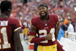 Washington Redskins cornerback Josh Norman (24) smiles with cornerback Will Blackmon (41) on the sidelines during the second half of an NFL football game against the Cleveland Browns, Sunday, Oct. 2, 2016, in Landover, Md. The Redskins won 31-20. (AP Photo/Chuck Burton)