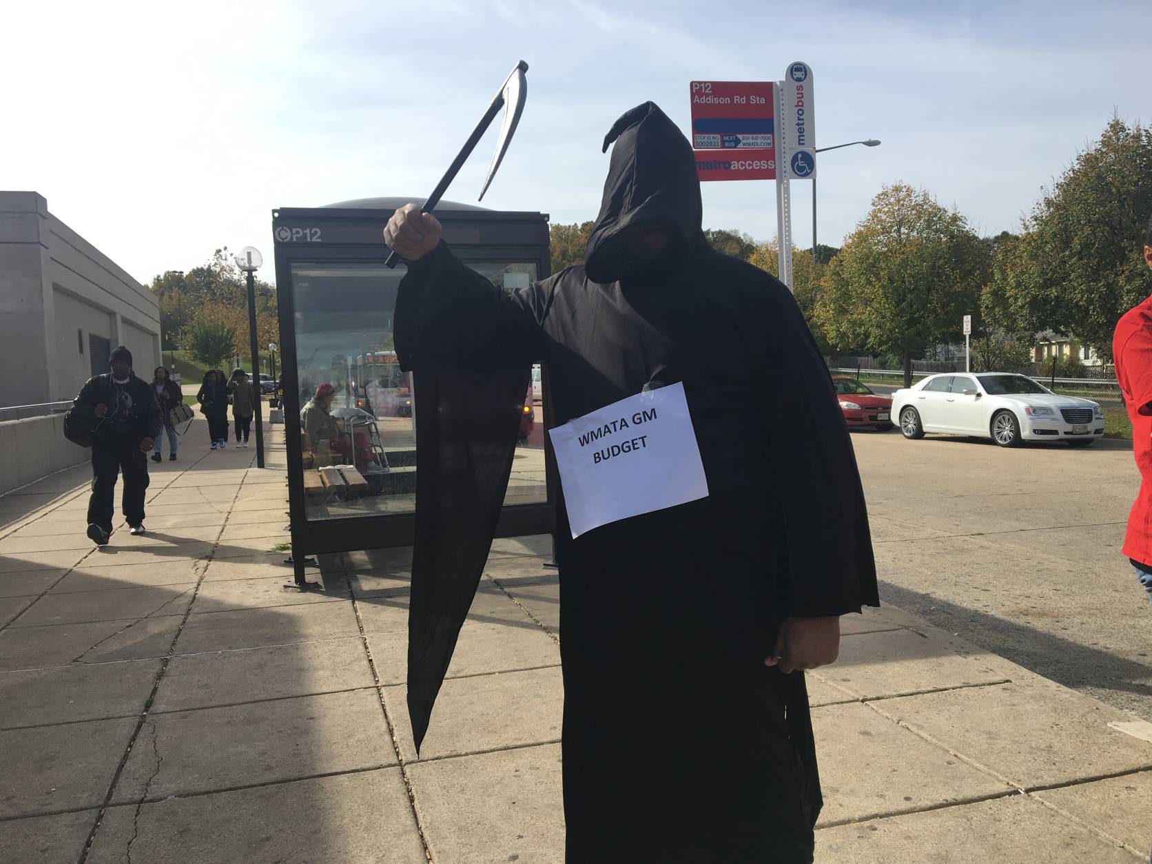 A costumed rallier outside Southern Avenue Metro station echoes the "death spiral" theme. In addition to proposed layoffs, union members are also concerned over cuts to worker benefits. (WTOP/Max Smith)