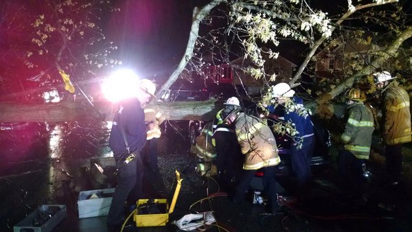 Rescuers from the College Park Fire Department work to free a person who was trapped after a tree fell onto a car on 49th Avenue near Hollywood Road on Saturday, April 2, 2016. (College Park Fire Department via Twitter)