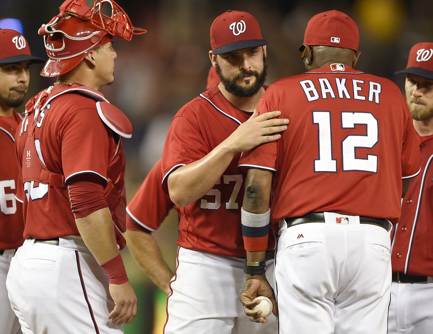 Washington Nationals starting pitcher Tanner Roark (57) is pulled form the baseball game by manager Dusty Baker (12) during the ninth inning against the Pittsburgh Pirates, Saturday, July 16, 2016, in Washington. Nationals catcher Wilson Ramos is at left. The Nationals won 6-0. (AP Photo/Nick Wass)