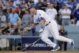 Los Angeles Dodgers' Chase Utley watches his RBI-single during the eighth inning in Game 4 of a baseball National League Division Series against the Washington Nationals in Los Angeles, Tuesday, Oct. 11, 2016. (AP Photo/Jae C. Hong)