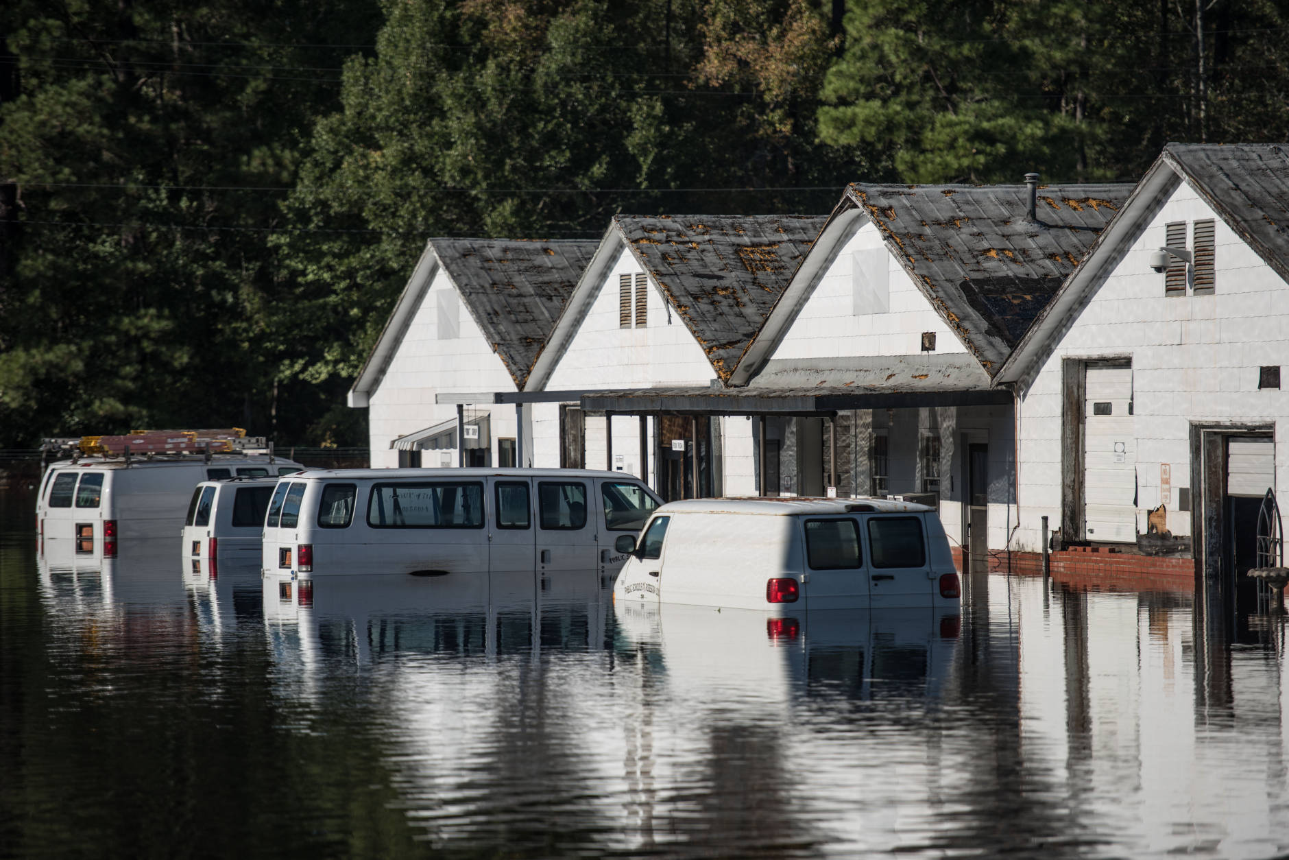 LUMBERTON, NC - OCTOBER 12: Vehicles are submerged vehicles at a Robeson County school parking lot on October 12, 2016 in Lumberton, North Carolina. Hurricane Matthew's heavy rains ended over the weekend, but flooding is still expected for days in North Carolina. (Photo by Sean Rayford/Getty Images)