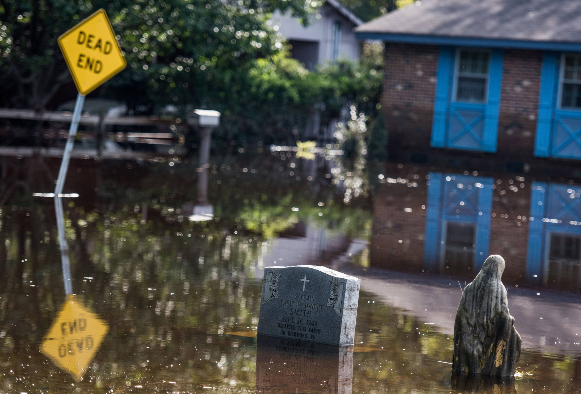 LUMBERTON, NC - OCTOBER 15: A graveyard is inundated with floodwaters from the Lumber River on October 15, 2016 in Lumberton, North Carolina. The flooding caused by Hurricane Matthew has been responsible for 26 deaths in the state. (Photo by Sean Rayford/Getty Images)