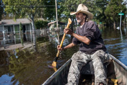 LUMBERTON, NC - OCTOBER 15: Harvey Wearnes paddles a canoe through a flooded street in his neighborhood on October 15, 2016 in Lumberton, North Carolina. The flooding caused by Hurricane Matthew has been responsible for 26 deaths in the state. (Photo by Sean Rayford/Getty Images)