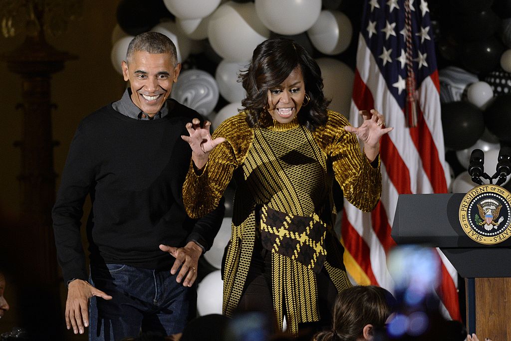 WASHINGTON, DC - OCTOBER 31: U.S. President Barack Obama and first lady Michelle Obama speak during a Halloween event in the East Room of the White House October 31, 2016 in Washington, DC. The first couple hosted local children and children of military families for trick-or-treating at the White House. (Photo by Olivier Douliery-Pool/Getty Images)