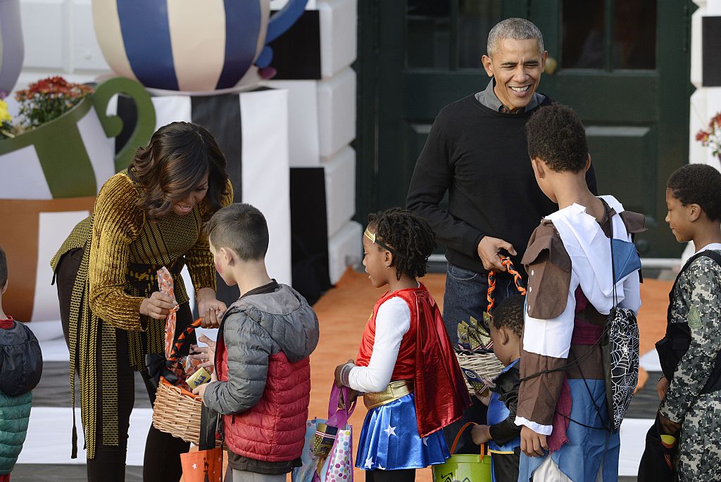 WASHINGTON, DC - OCTOBER 31: U.S. President Barack Obama and first lady Michelle Obama hand out treats during a Halloween event at the South Lawn of the White House October 31, 2016 in Washington, DC. The first couple hosted local children and children of military families for trick-or-treating at the White House. (Photo by Olivier Douliery-Pool/Getty Images)