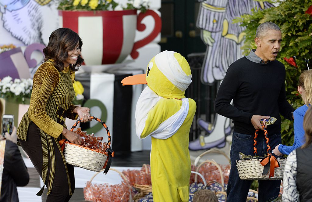 WASHINGTON, DC - OCTOBER 31: U.S. President Barack Obama and first lady Michelle Obama hand out treats to a child dressed as a 'lame duck' during a Halloween event at the South Lawn of the White House October 31, 2016 in Washington, DC. The first couple hosted local children and children of military families for trick-or-treating at the White House. (Photo by Olivier Douliery-Pool/Getty Images)