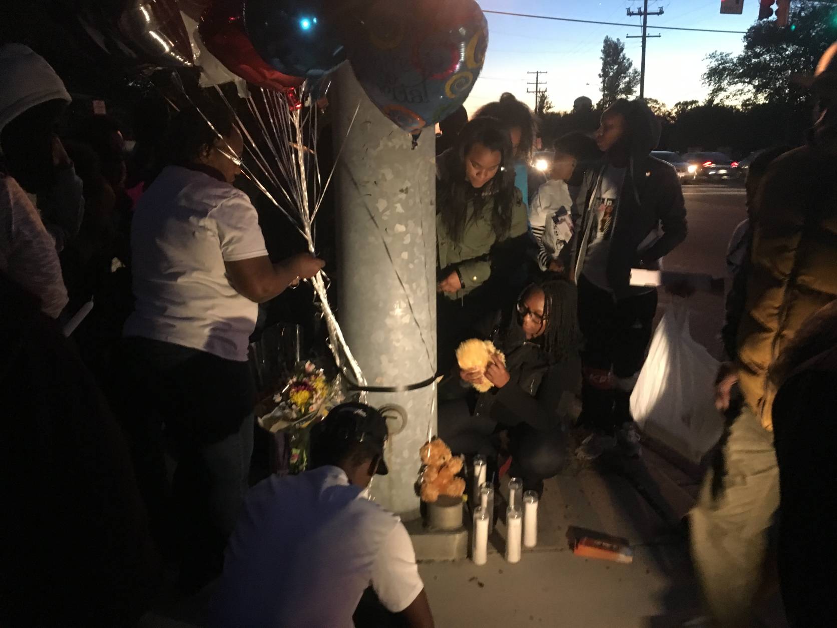 Family and friends gathered at the intersection of St. Barnabas Road and Wheeler Road Monday, Oct. 10 to remember 23-year-old Kishon Wiggins, who was struck and killed at the intersection. (WTOP/Mike Murillo)