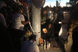 Family and friends gathered at the intersection of St. Barnabas Road and Wheeler Road Monday, Oct. 10 to remember 23-year-old Kishon Wiggins, who was struck and killed at the intersection. (WTOP/Mike Murillo)