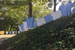 The 200 T-Shirts line both sides of the driveway up to the temple. (WTOP/Megan Cloherty)