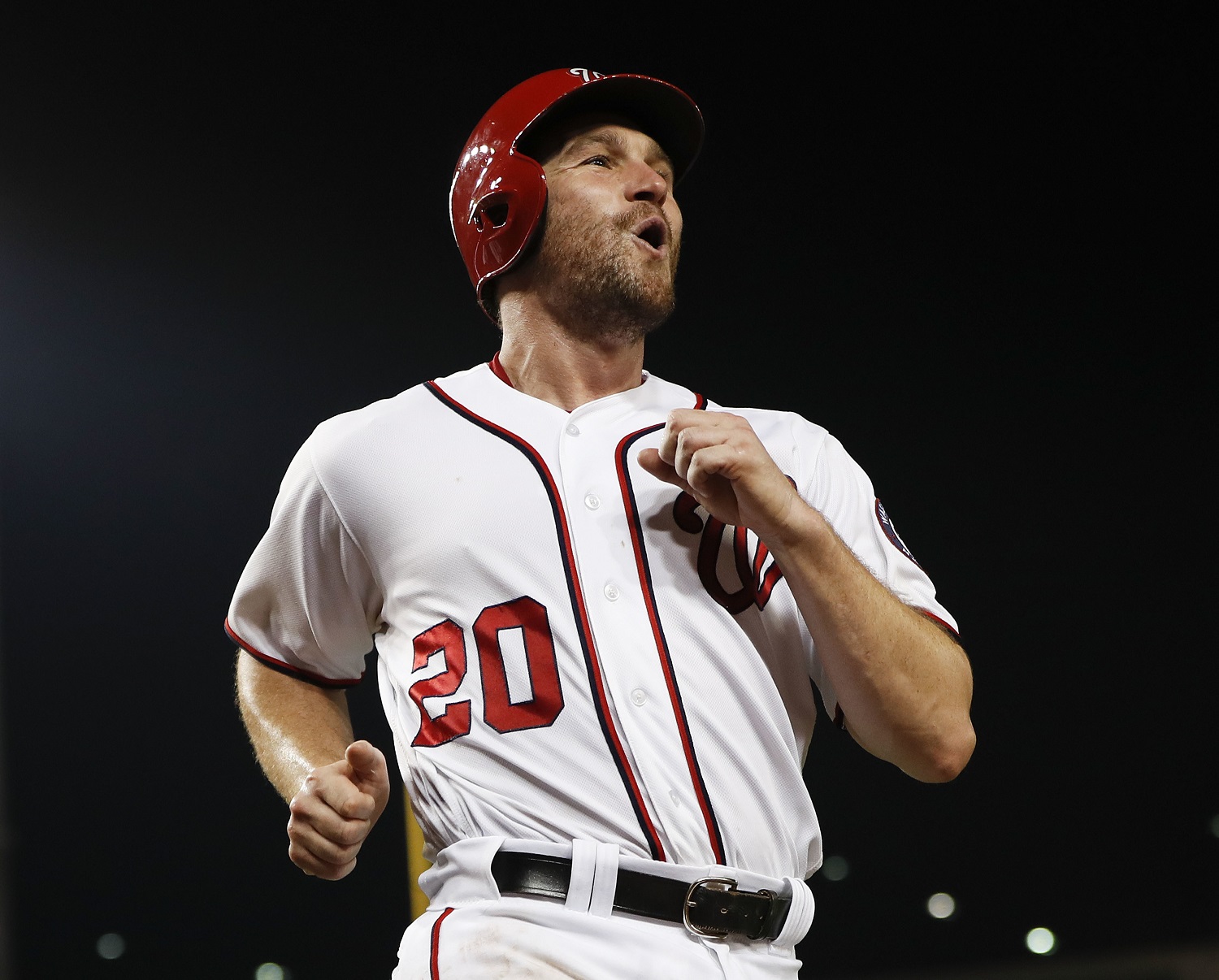 Washington Nationals' Daniel Murphy celebrates as he crosses home while scoring on a triple hit by teammate Bryce Harper during a baseball game against the Colorado Rockies at Nationals Park, Friday, Aug. 26, 2016 in Washington. (AP Photo/Pablo Martinez Monsivais)