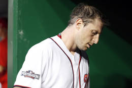 Washington Nationals starting pitcher Max Scherzer (31) walks out of the dugout after pitching the third inning of Game 1 of baseball's National League Division Series against the Los Angeles Dodgers, at Nationals Park, Friday, Oct. 7, 2016, in Washington. (AP Photo/Alex Brandon)