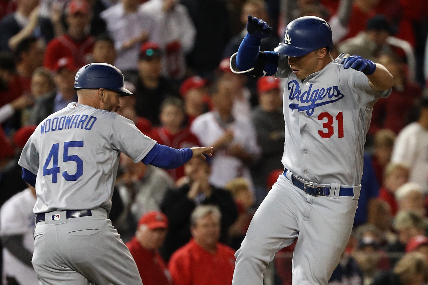 WASHINGTON, DC - OCTOBER 13: Joc Pederson #31 of the Los Angeles Dodgers celebrates with third base coach Chris Woodward #45 after hitting a solo home run in the seventh inning against the Washington Nationals during game five of the National League Division Series at Nationals Park on October 13, 2016 in Washington, DC. (Photo by Patrick Smith/Getty Images)
