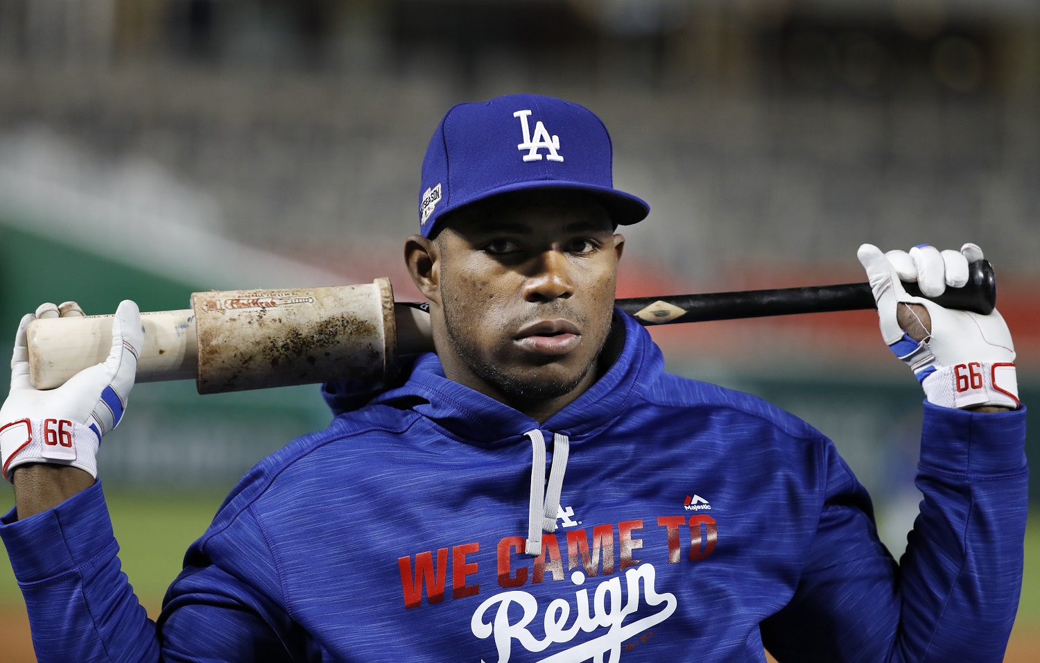 Los Angeles Dodgers right fielder Yasiel Puig warms up during baseball batting practice at Nationals Park, Wednesday, Oct. 5, 2016, in Washington. The Nationals host the Los Angeles Dodgers in Game 1 of the National League Division Series baseball game on Friday. (AP Photo/Alex Brandon)