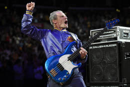 FILE - In this April 13, 2014 file photo, Flea, bassist for the Red Hot Chili Peppers, plays the national anthem prior to an NBA basketball game between the Los Angeles Lakers and the Memphis Grizzlies in Los Angeles. The Super Bowl takes place a week before the Grammys, but the big game is rivaling the awards shows with a plethora of live concerts and on-site musicians, from the Red Hot Chili Peppers and Metallica to Pharrell and Skrillex.  (AP Photo/Mark J. Terrill, File)