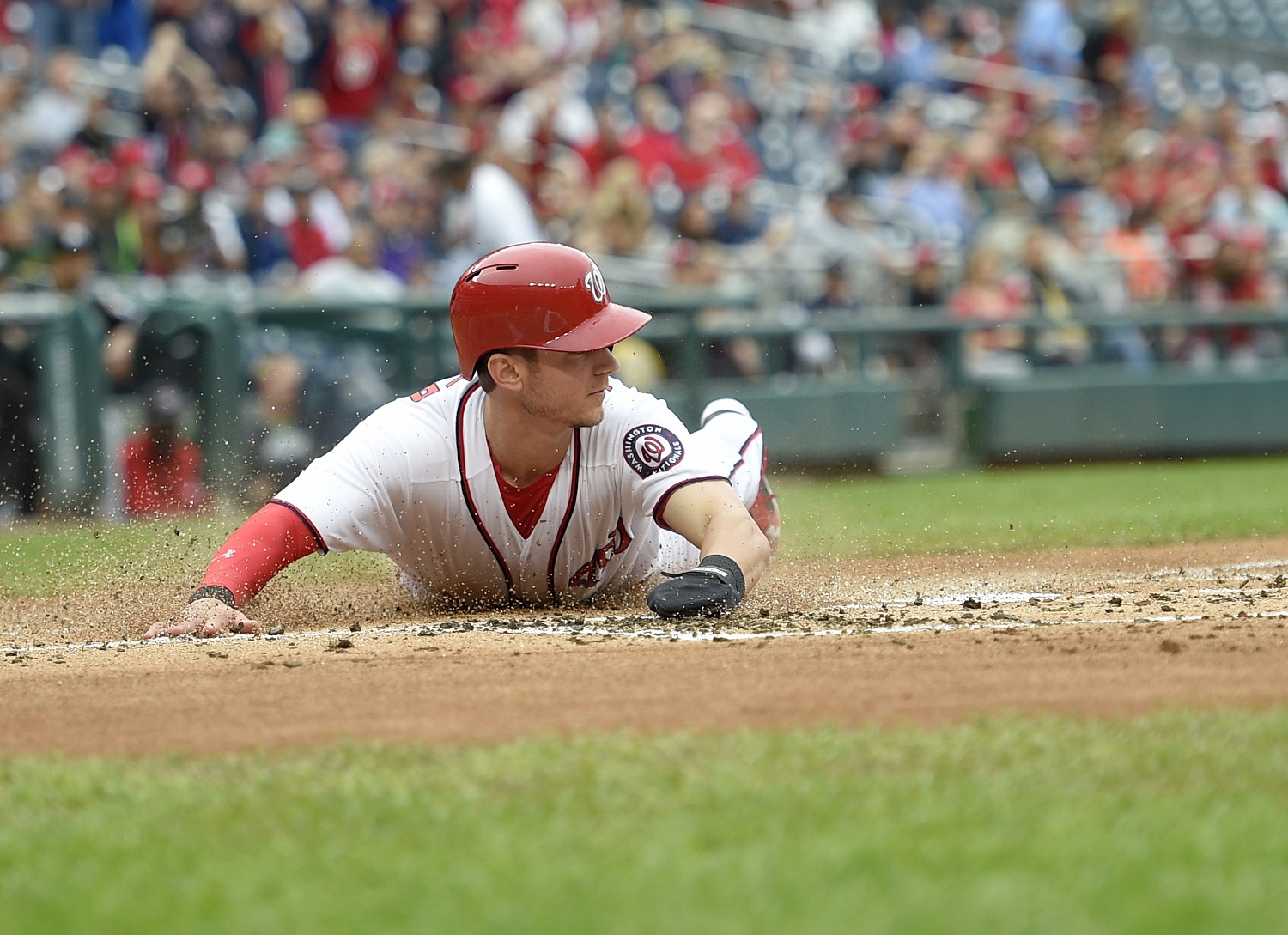 Washington Nationals' Trea Turner slides home to score a run on a single by Bryce Harper during the first inning of a baseball game against the Miami Marlins, Saturday, Oct. 1, 2016, in Washington. (AP Photo/Nick Wass)