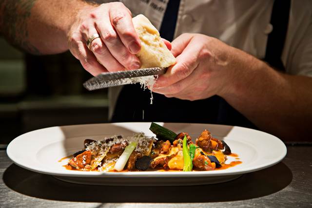 Ethan McKee, executive chef at Urbana, puts puts the finishing touches on a plate of fresh pasta. (Courtesy Urbana) 