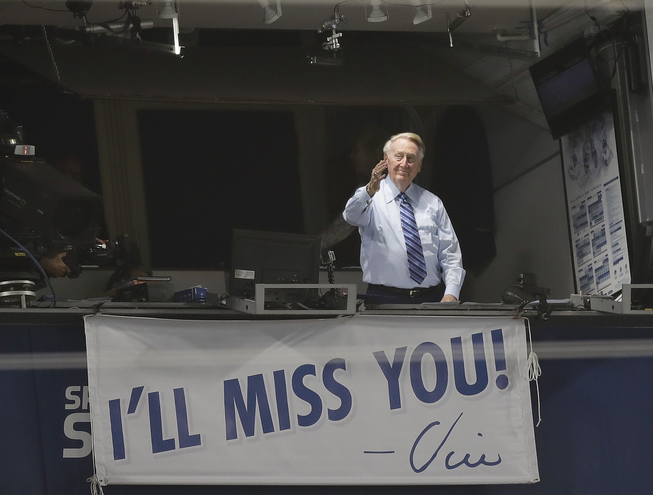 Los Angeles Dodgers broadcaster Vin Scully gestures in his booth during a baseball game between the Los Angeles Dodgers and the Colorado Rockies, Friday, Sept. 23, 2016, in Los Angeles. Scully's final game at Dodger Stadium will be Sunday against the Rockies. (AP Photo/Jae C. Hong)