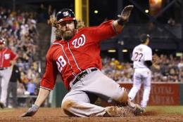 Washington Nationals' Jayson Werth scores on a sacrifice fly by Anthony Rendon in the fourth inning of a baseball game against the Pittsburgh Pirates in Pittsburgh, Saturday, Sept. 24, 2016. (AP Photo/Gene J. Puskar)